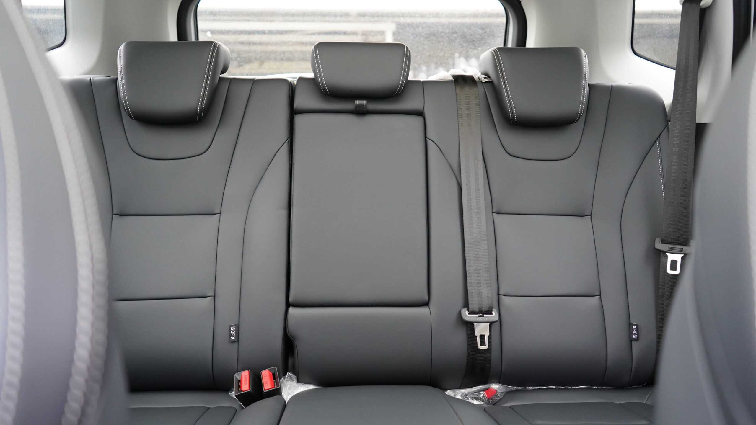 Rear car row with three dark gray seats, headrests, and visible ISOFIX anchors on the outer seats.