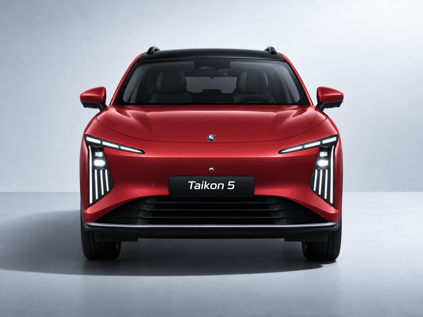Front view of a red Taikon 5 SUV with angular LED headlights and a bold grille of the car facing the camera.